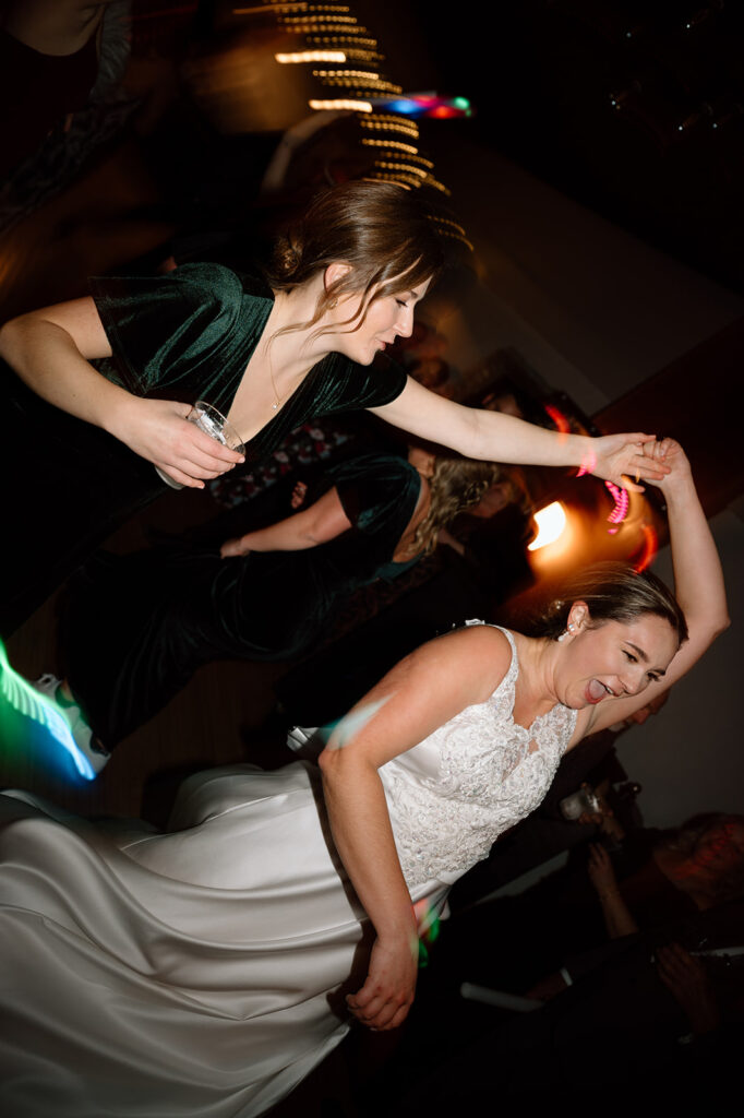 Bride and bridesmaid dancing at wedding reception