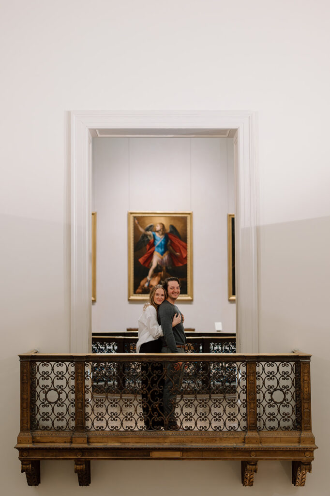 Couple standing on a balcony at an art gallery
