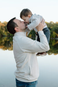 Dad kissing his one year-old son on the nose