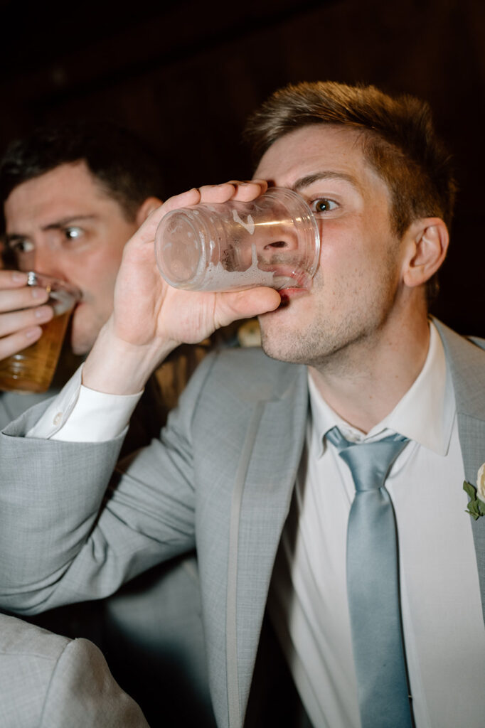 Groomsmen chugging beer